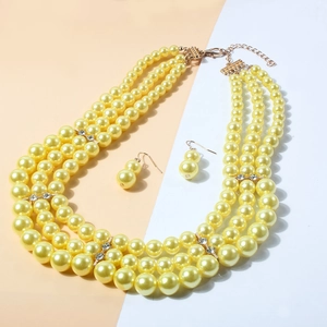Detail of multi-layer yellow pearl necklace with rhinestone gold spacers and matching earrings