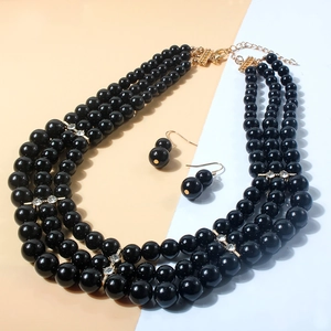 Elegant multi-layer black pearl necklace set with matching drop earrings and gold accents
