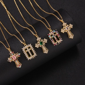 Gold plated cross pendant necklaces with colorful zircon stones on black display