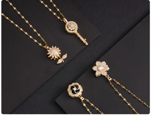 Detail of four golden rotating pendants with micro-pave cubic zirconia on slim chains