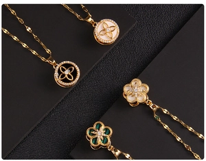 Macro detail of rotating clover pendants with shimmering zircon and gold plated chains
