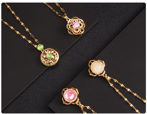 Detail of gold titanium steel necklaces with zircon clover pendants in four colors