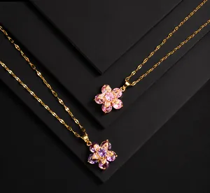 Detail of rotating four-leaf clover pendant necklace with pink and purple zircon stones