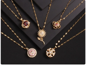 Detail shot of five gold necklaces featuring zircon clover and floral heart pendants