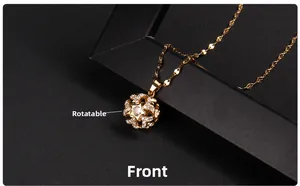 Close-up of golden spinning clover pendant with white zircon stones on titanium chain