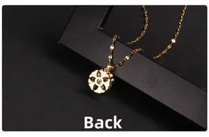 Detailed back view of the golden rotating four-leaf clover pendant on a slim chain