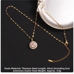 Detailed view of rotating clover necklace with pink gemstone and white zircon setting