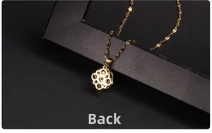 Detailed back view of golden rotating clover pendant with smooth polished metal finish