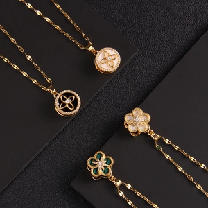 Golden rotating clover and flower pendant necklace set with zircon and mother of pearl