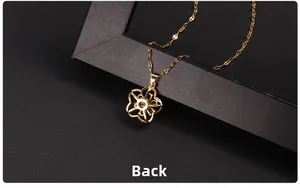 Detailed back view of golden clover pendant showing hollowed petals and twist chain
