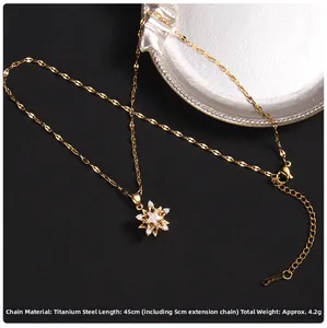 Detail view of a 45cm gold titanium steel necklace with a zircon star pendant and extension