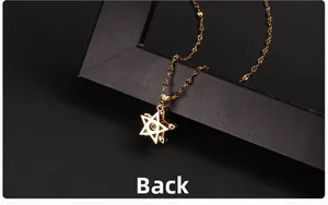 Macro shot of the back side of a gold star pendant necklace with zircon centerpiece