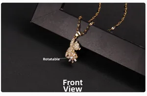 Close-up of rotatable golden cat pendant with cubic zirconia on a delicate chain