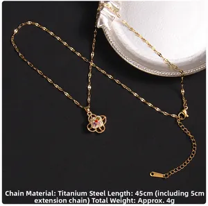 Detail of gold titanium clover necklace with colorful zircons and 5cm extension chain
