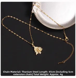 Detailed close-up of a golden Christmas tree pendant with zircons and snowflake detail