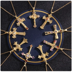 Detailed arrangement of nine gold-plated cross pendants with colorful zircon inlay