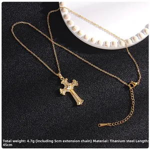 Detail of 45cm gold titanium cross necklace with micro-pave cubic zirconia and lobster clasp