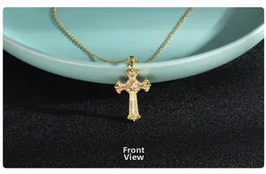 Front view of baroque gold cross necklace with micro-p镶 inlaid zircons on a green plate