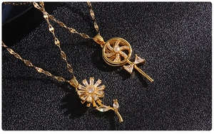 Close-up of golden windmill and sunflower pendants with micro-set zircon details