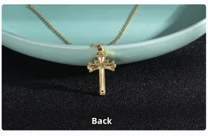 Macro shot of the polished gold cross pendant reverse side showing intricate hollow detail