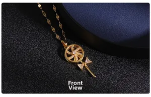 Front view of spinning gold necklace with cubic zirconia windmill and bowknot detail