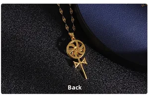 Macro view of the gold windmill necklace pendant back side with fine metal texture