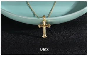 Macro view showing the back side of the gold-plated cross pendant with hollow-out detail