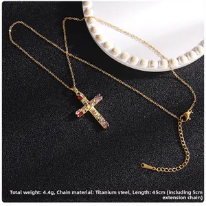 Detail of 45cm gold titanium cross necklace with colorful zircon gemstones