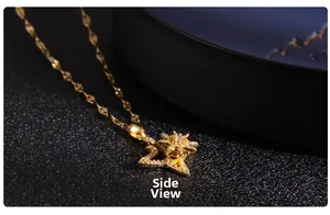 Detailed side view of golden windmill pendant with sparkling heart-shaped zircon stones