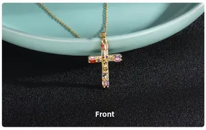 Detailed macro view of gold cross pendant with colorful zircon stones and Jesus figure