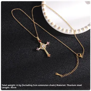 Detailed macro view of the gold cross necklace with inlaid zircon on dark leather