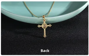 Detail view showing the golden cross pendant back side with intricate hollow metalwork