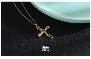 Side view of golden cross pendant necklace with colorful rectangular gemstones and O-chain