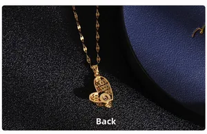 Macro shot of the back side of a gold heart pendant necklace with fine metal chain