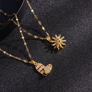 Luxury gold-plated heart and starburst necklaces with zircon stones on black background