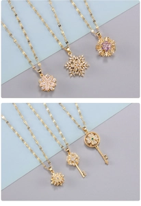 Detailed macro view of golden snowflake and flower pendants with zircon stones