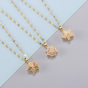 Three gold flower pendant necklaces with colorful, purple, and white rhinestones