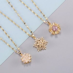 Elegant gold plated spinning snowflake and floral pendant necklaces with zircon inlay