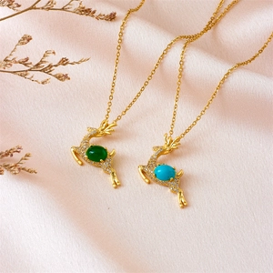 Elegant gold Christmas reindeer necklaces with emerald green and blue zircon pendants
