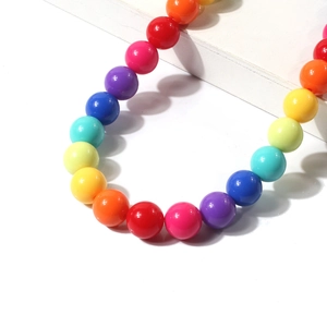 Rainbow bead pet collar with colorful geometric round beads on a white display stand
