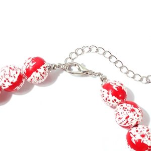 Detail of Halloween necklace showing bloody splatter beads and silver lobster clasp closure