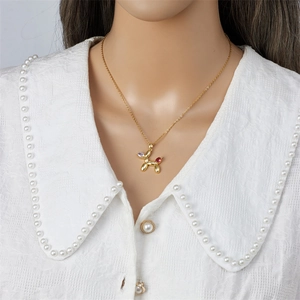 Gold balloon dog necklace for women featuring vibrant purple and pink marquise gems