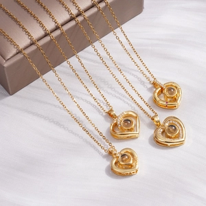 Golden heart projection necklace with I Love You in 100 languages and LOVE engraving