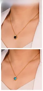 Detail of vintage heart pendant necklaces with black and blue zircons on model