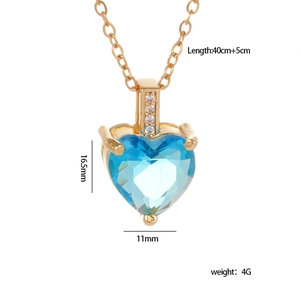 Vintage gold heart necklace with light blue heart-cut stone and white zircon accents