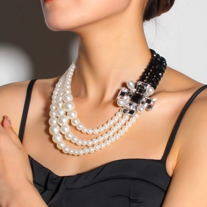 Vintage multi-layer necklace with black beads, white pearls and a crystal cross pendant