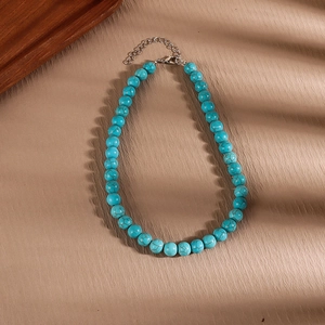 Detail of turquoise beaded necklace with silver lobster clasp and adjustable metal chain