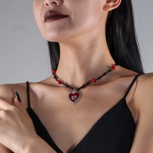 Gothic beaded necklace with red heart pendant and eye motif on a black cord