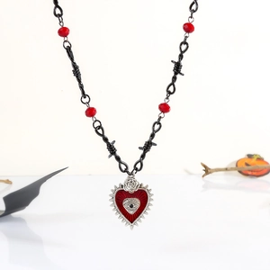Gothic barbed wire necklace with a red heart, silver rose, and devil eye pendant