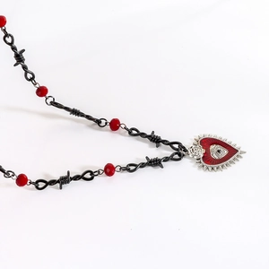 Gothic barbed wire necklace featuring red enamel heart, rose, and evil eye pendant